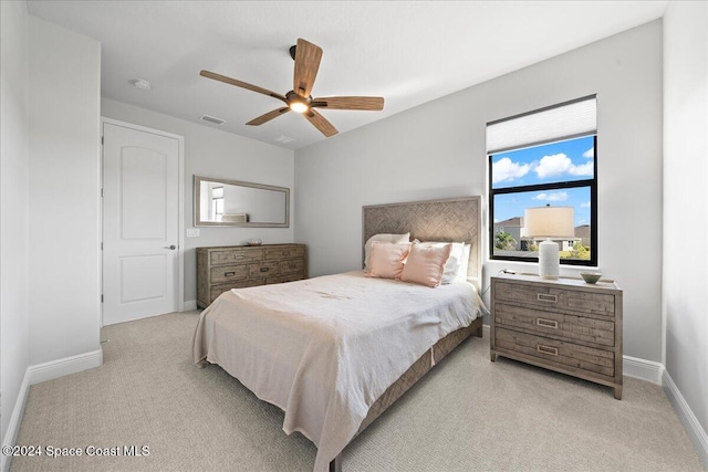 bedroom featuring ceiling fan and light colored carpet