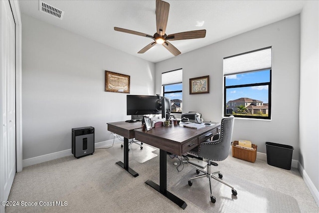 carpeted office featuring ceiling fan