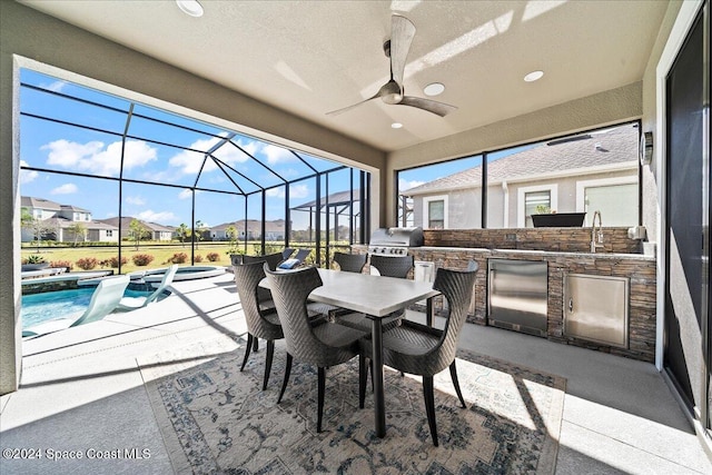 view of patio / terrace featuring ceiling fan, an outdoor kitchen, a lanai, area for grilling, and a swimming pool with hot tub