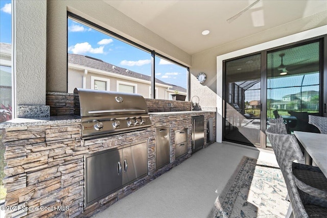 view of patio with area for grilling and exterior kitchen