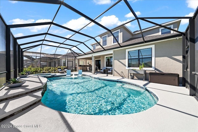 view of pool with an in ground hot tub, a patio, and a lanai