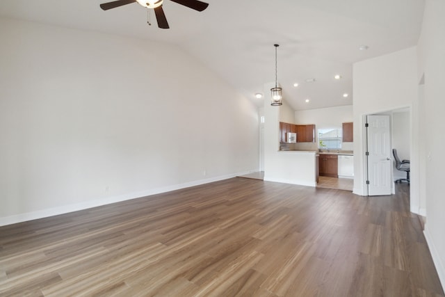 unfurnished living room featuring ceiling fan, hardwood / wood-style floors, and vaulted ceiling