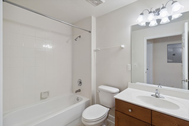 full bathroom with vanity, electric panel, tiled shower / bath combo, toilet, and a textured ceiling