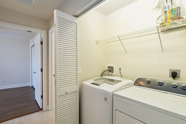 washroom featuring washer and dryer and light wood-type flooring