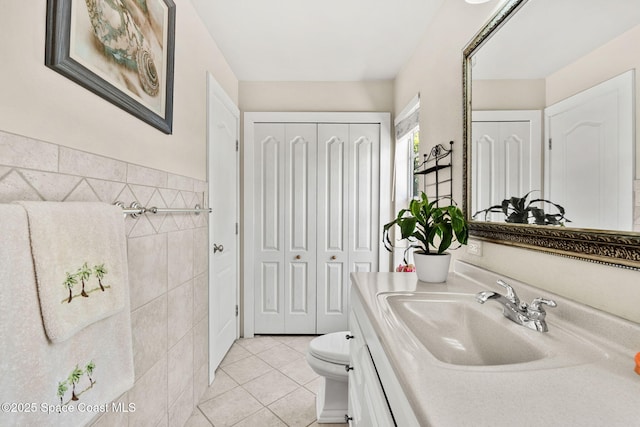 36 Vip Is Unit A, Grant, FL 32949 - bathroom featuring a closet, tile patterned flooring, tile walls, toilet, and vanity