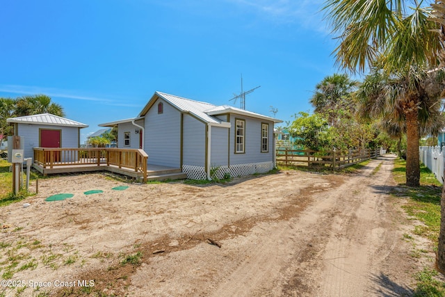 36 Vip Is Unit A, Grant, FL 32949 - view of property exterior featuring fence, a deck, and metal roof