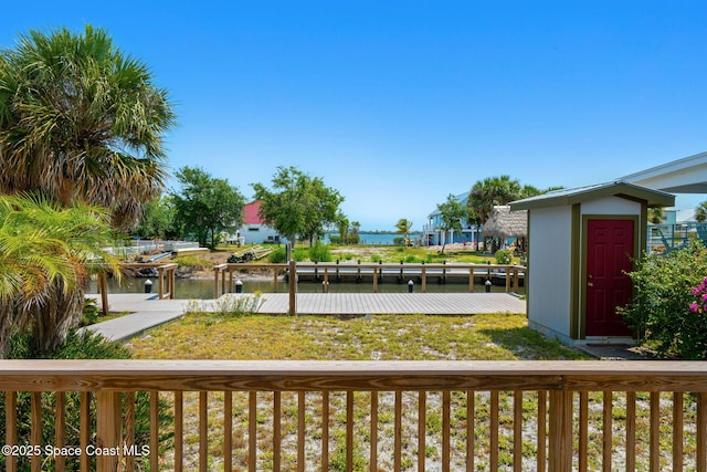 36 Vip Is Unit A, Grant, FL 32949 - deck featuring a water view, a storage shed, a dock, and an outdoor structure