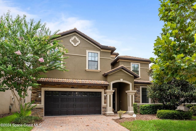 mediterranean / spanish house featuring a garage