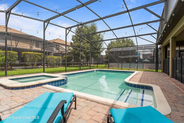 view of swimming pool with glass enclosure, an in ground hot tub, and a patio