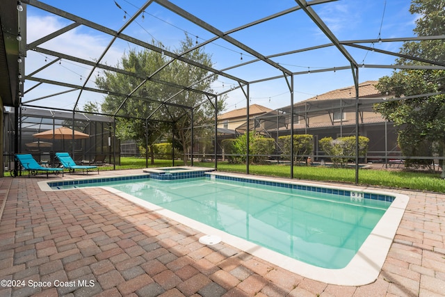 view of pool with glass enclosure and a patio