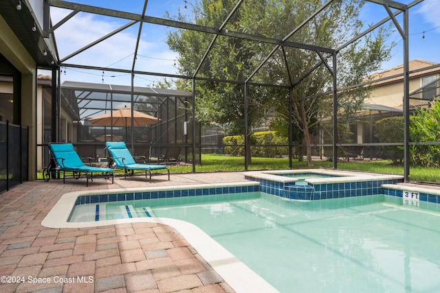 view of pool featuring a lanai, a patio area, and an in ground hot tub