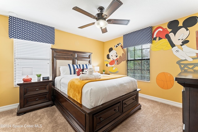 bedroom featuring ceiling fan and light carpet