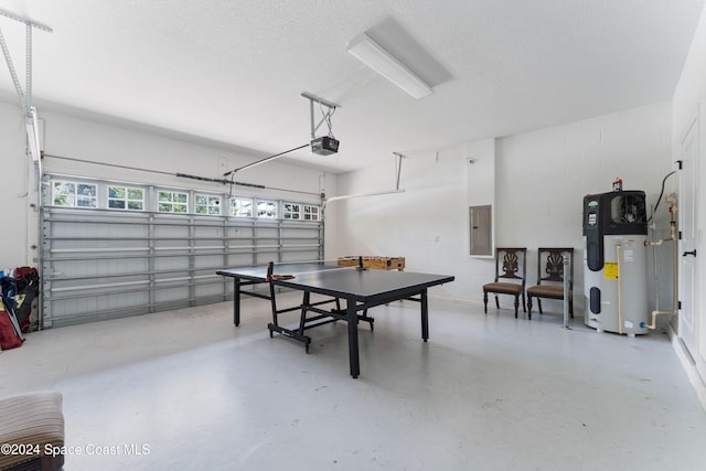 garage featuring electric panel, a garage door opener, and hybrid water heater