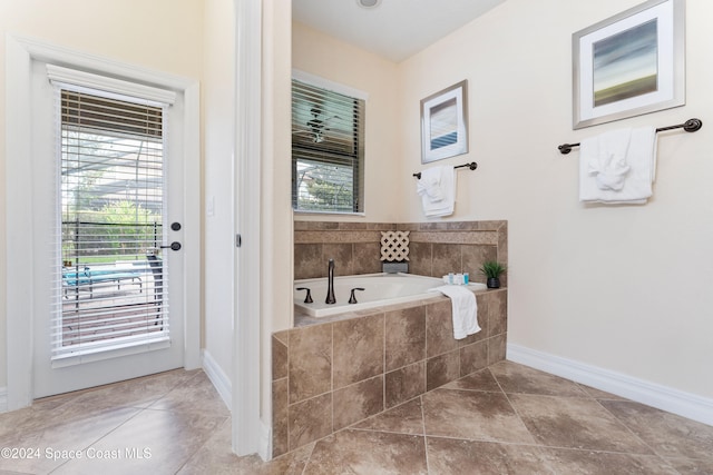 bathroom featuring a relaxing tiled tub and tile patterned floors