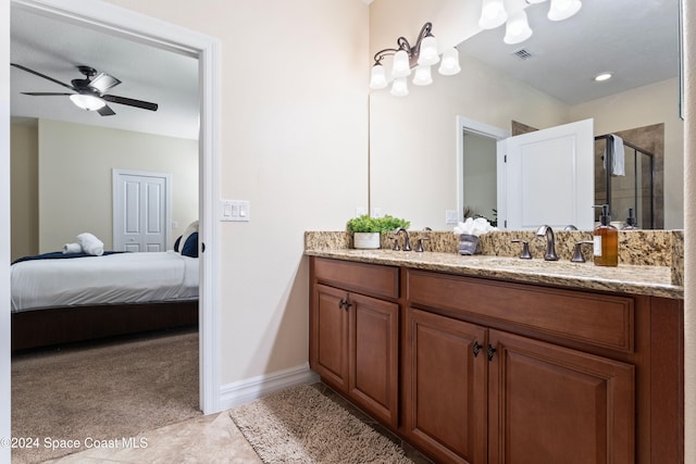 bathroom with tile patterned floors, ceiling fan, vanity, and a shower with shower door