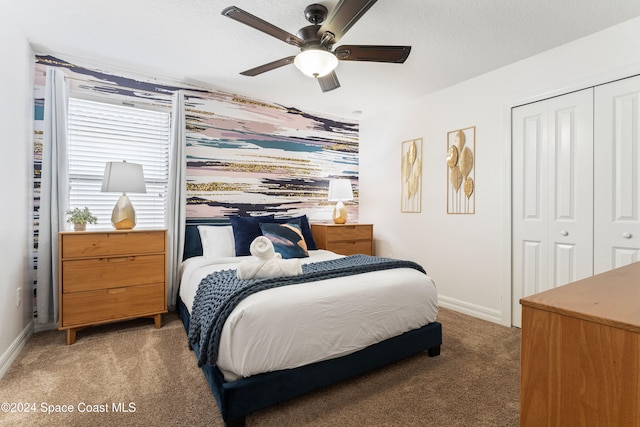 bedroom with ceiling fan, a closet, and carpet