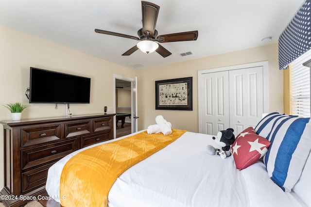 bedroom with ceiling fan and a closet