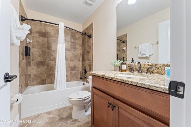 full bathroom featuring shower / bath combination with curtain, vanity, a textured ceiling, tile patterned flooring, and toilet