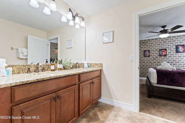 bathroom with vanity, tile patterned floors, ceiling fan, and brick wall