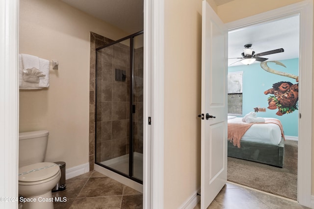 bathroom featuring tile patterned floors, ceiling fan, toilet, and a shower with shower door