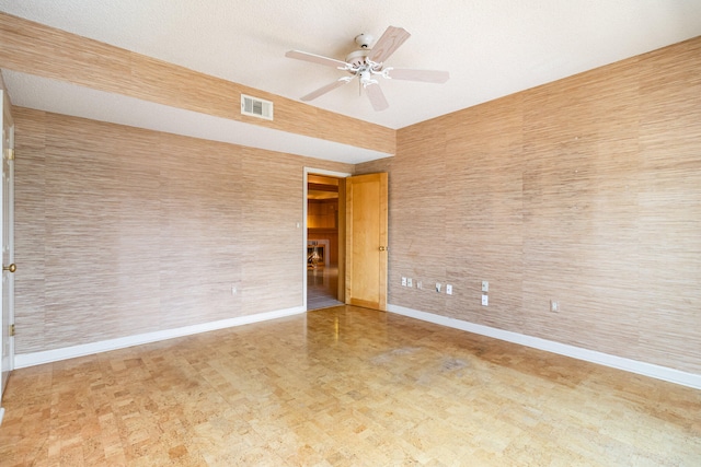 empty room featuring ceiling fan and a textured ceiling