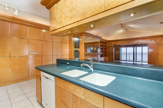 kitchen with sink, white dishwasher, track lighting, and vaulted ceiling