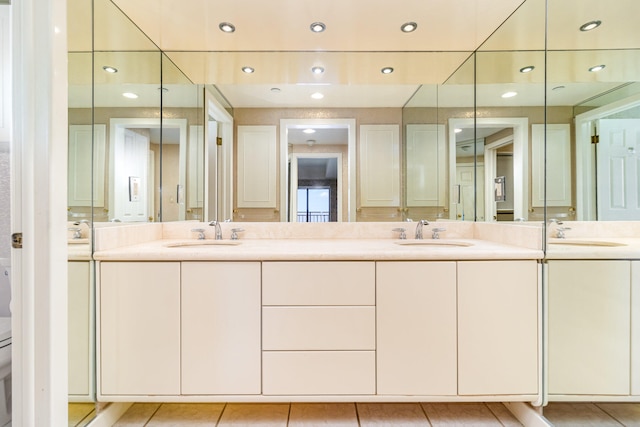 bathroom featuring tile patterned floors, vanity, and toilet