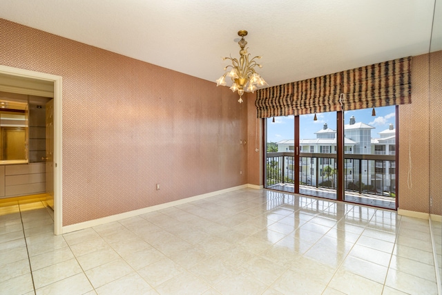 spare room with a chandelier