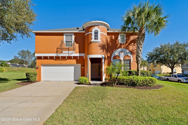 view of front of home with a front yard and a garage