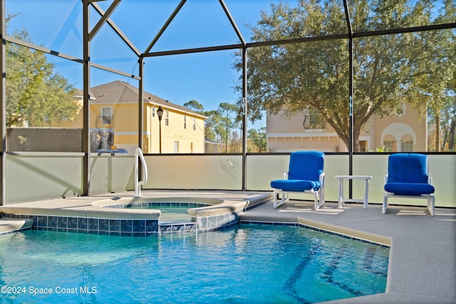 view of pool featuring sink, a lanai, an in ground hot tub, and a patio