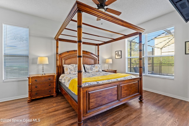 bedroom featuring a textured ceiling, ceiling fan, and dark wood-type flooring