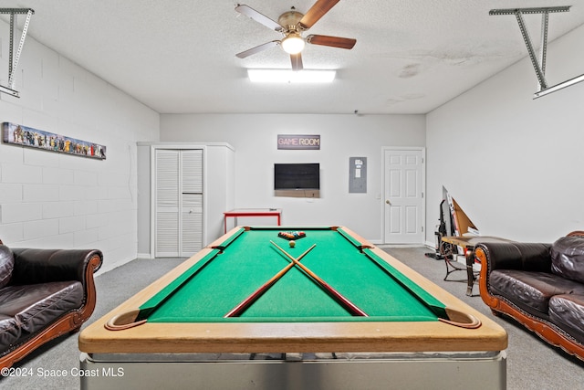 playroom with ceiling fan, electric panel, a textured ceiling, carpet, and pool table