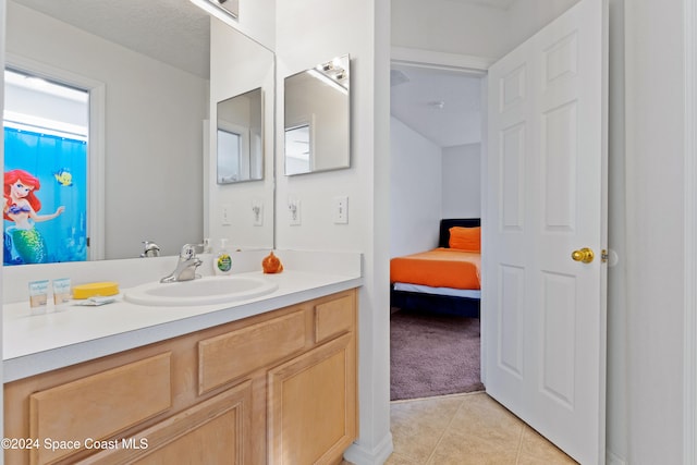 bathroom featuring tile patterned flooring, a textured ceiling, and vanity