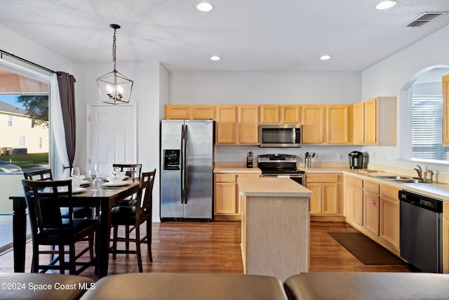 kitchen featuring plenty of natural light, light brown cabinets, and stainless steel appliances