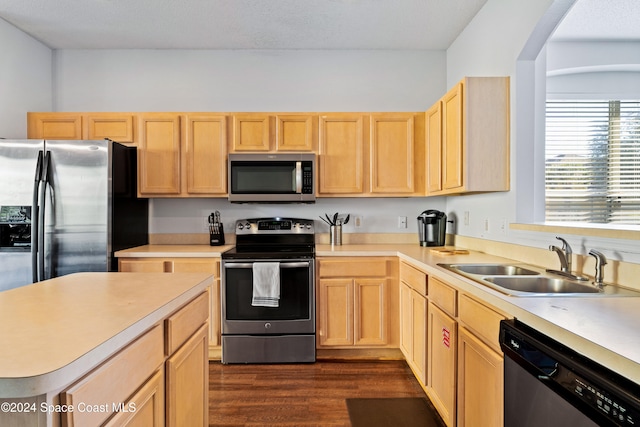 kitchen with dark hardwood / wood-style flooring, sink, stainless steel appliances, and light brown cabinetry