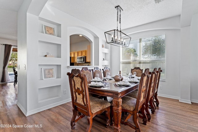 dining area featuring a wealth of natural light, built in features, and hardwood / wood-style floors