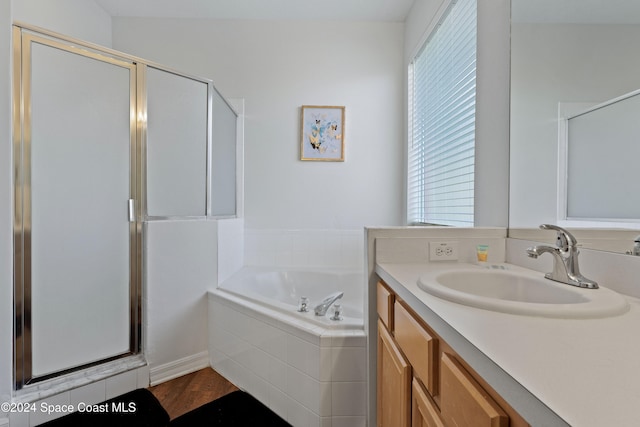 bathroom with vanity and independent shower and bath