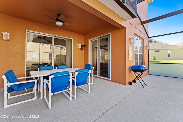 view of patio with ceiling fan, a lanai, and a grill