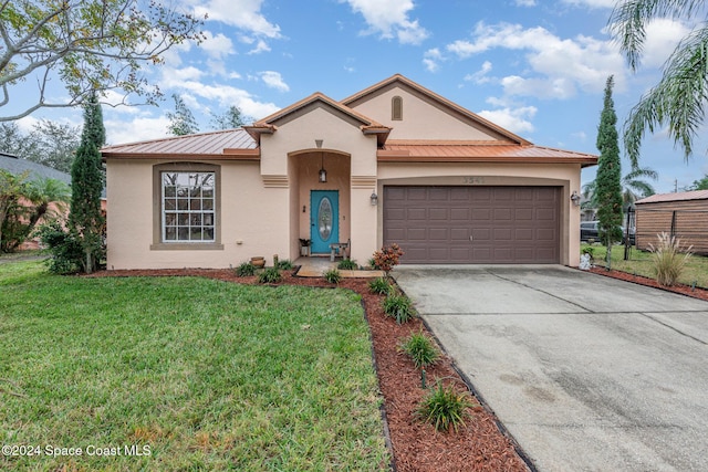 view of front of home with a garage and a front lawn