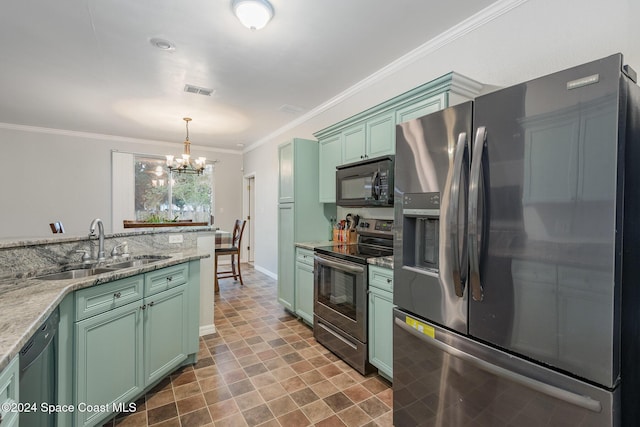 kitchen featuring appliances with stainless steel finishes, crown molding, sink, decorative light fixtures, and a chandelier