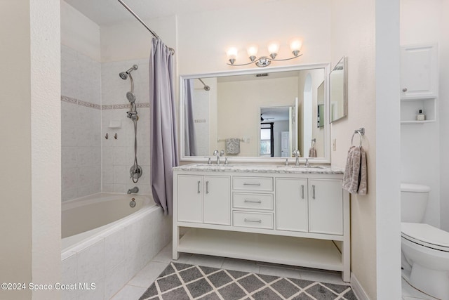 full bathroom with tile patterned flooring, vanity, toilet, and shower / bath combo with shower curtain