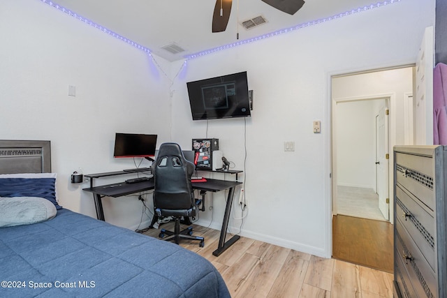 bedroom with light hardwood / wood-style floors and ceiling fan