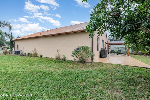 view of side of home with a gazebo, a yard, a patio, and central air condition unit