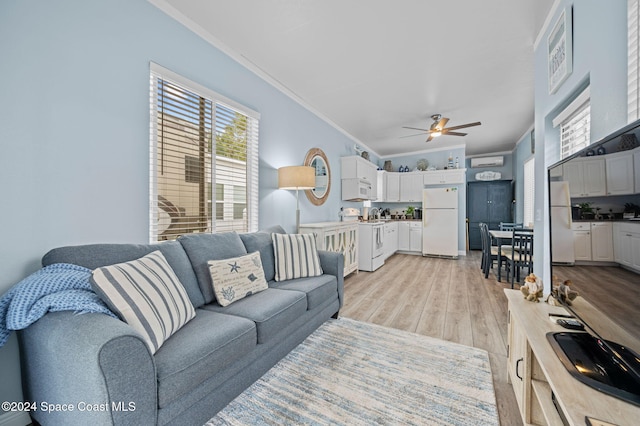 living room featuring light hardwood / wood-style flooring, ceiling fan, and crown molding