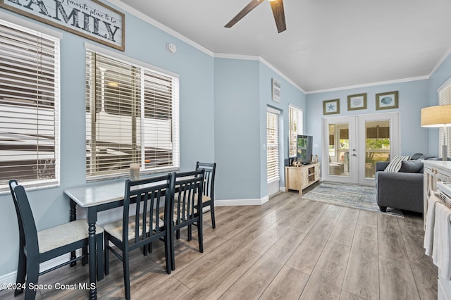 dining room featuring ceiling fan, light hardwood / wood-style floors, crown molding, and french doors