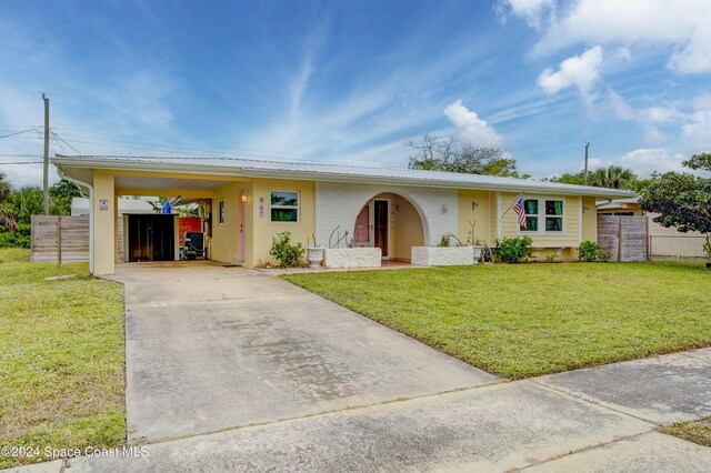 ranch-style home with a front yard and a carport