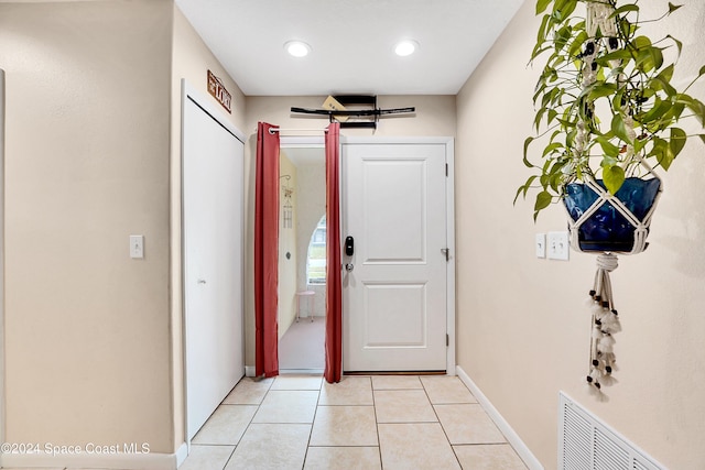 entryway with light tile patterned floors