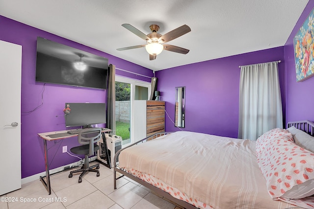 tiled bedroom with a textured ceiling and ceiling fan