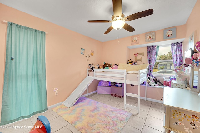 tiled bedroom with ceiling fan