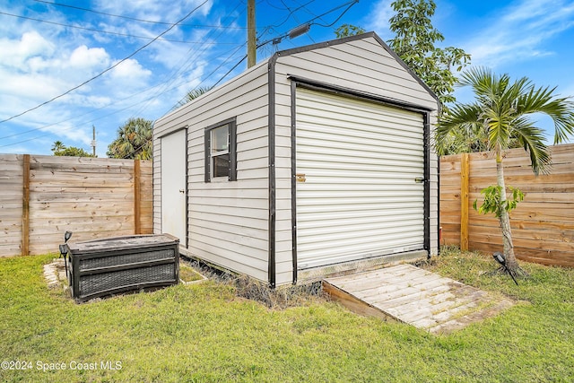 view of outbuilding with a yard